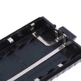 Close-up of unbranded Baofeng UV-5R battery case box showing metal contacts and black plastic casing