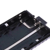 Close-up of unbranded Baofeng UV-5R battery case box showing metal contacts and black plastic casing