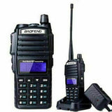 Baofeng UV-82 dual band two-way radio with keypad and LCD display on charging dock