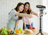 BOYA BM2021 shotgun microphone mounted on a smartphone for clear audio during filming with friends