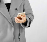 Person holding phone with BOYA BY-DM1 Lightning mic clipped on coat for clear audio recording