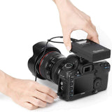 BOYA RX8 Pro dual channel receiver mounted on Canon camera with hands adjusting connections