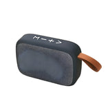Cloth covered Bluetooth speaker in sleek design with easy-to-use controls and a carry strap