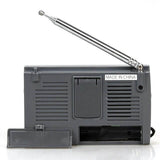 Back view of KCHIBO KK-9803 shortwave radio with extended antenna and battery compartment open
