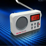 White compact AM FM alarm clock radio with digital display, speaker, and extendable antenna