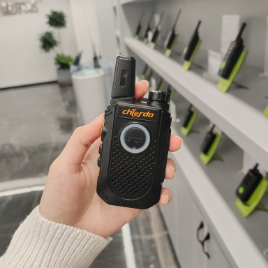 Chierda CD-X9 programming software on a handheld two-way radio held in a hand, ideal for communication