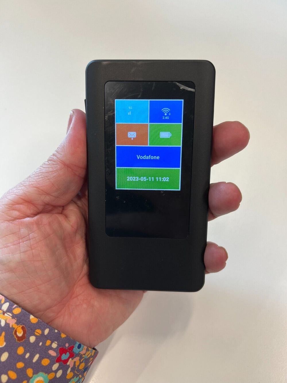 5G mobile Wi-Fi device UK in hand displaying connection status and network options