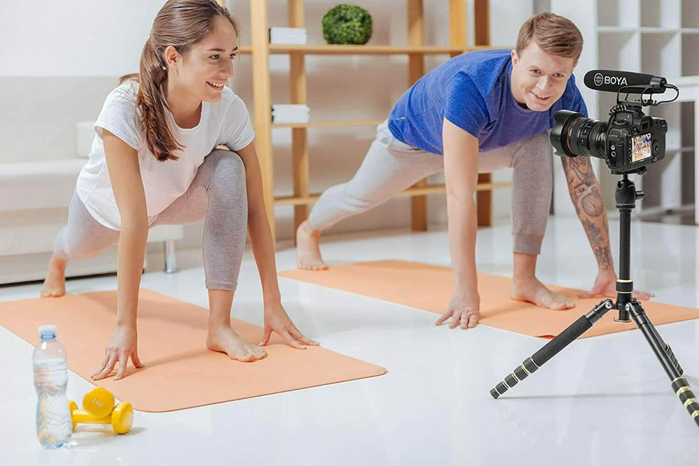 BOYA BM2021 shotgun microphone mounted on a camera capturing a yoga session in a bright studio