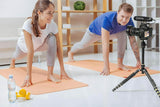 BOYA BM2021 shotgun microphone mounted on a camera capturing a yoga session in a bright studio