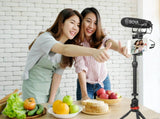 BOYA BM2021 shotgun microphone mounted on a smartphone for clear audio during filming with friends