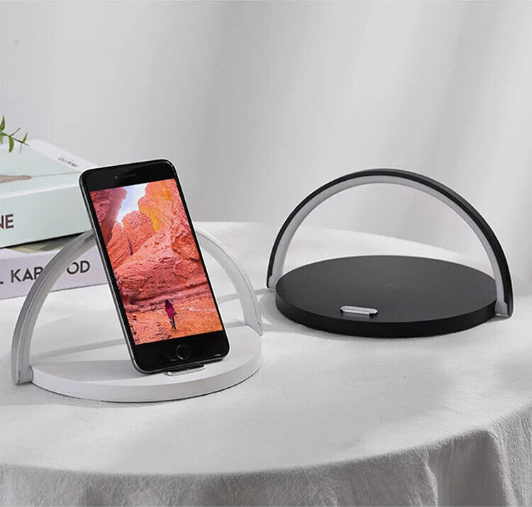 Sleek LED desk lamp with wireless charger, featuring a modern design and space for a smartphone