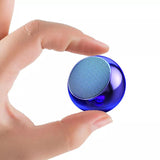 Compact blue mini Bluetooth speaker UK held between fingers, perfect for portable audio