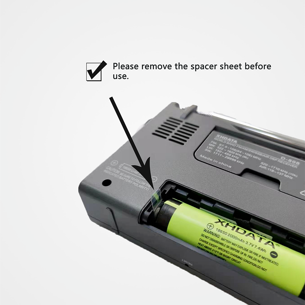 XHDATA D-808 digital radio showing battery compartment and removal instructions for spacer sheet